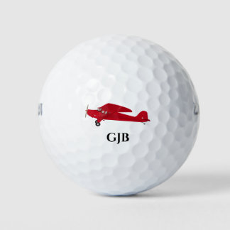 Vintage rote Golfbälle mit Flugzeug