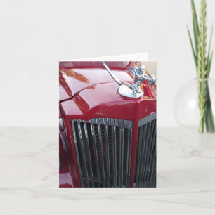 vintage roter Auto-Chrom-Motorhauben-Ornament auf Karte
