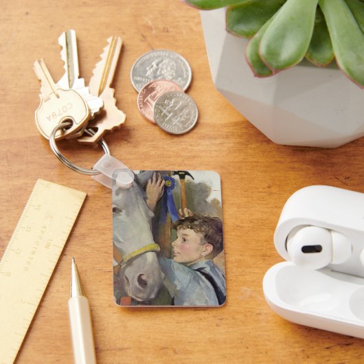 Vintager Junge mit seinem blauen Ribbon-Siegespfer Schlüsselanhänger (Schreibtisch)