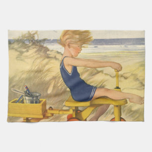 Vintager Junge spielt am Strand mit Sandspielzeug Geschirrtuch