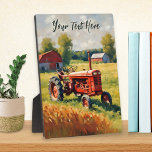Vintager roter Traktor im rustikalen Feldbild Fotoplatte<br><div class="desc">Diese nostalgische Tafel zeigt ein Retro-Bild eines roten Traktors in einem Feld. Ideal für Vintage Traktorfreunde,  das Bild zeigt eine ruhige Landschaft voller rustikaler Charme. Personalisieren Sie für einen besondere Anlass mit Ihren eigenen Worten in eleganter Schriftzypografie an der Spitze.</div>