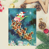 Vintager Weihnachtsmann fliegt Rentier über Häuser Postkarte