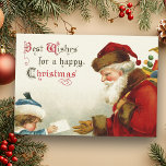 Vintager Weihnachtsmann und Kind mit Weihnachtsbri Feiertagskarte<br><div class="desc">Nostalgisches Bild eines rot-roten Weihnachtsmannes aus der Viktorianischen Zeit,  der eine Tüte Spielzeug trägt,  das einen Brief von einem schüchternen Kind in blauer Mantel und Hut bekommt. Komplementares Bild auf der Rückseite mit anpassbarem Text.</div>