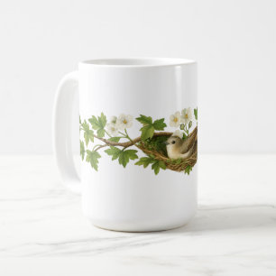 Vogel im Vogelnest auf blühenden Zweigen Kaffeetasse