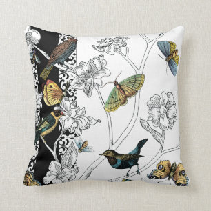 Vögel und Schmetterling auf einem schwarzen u. Kissen