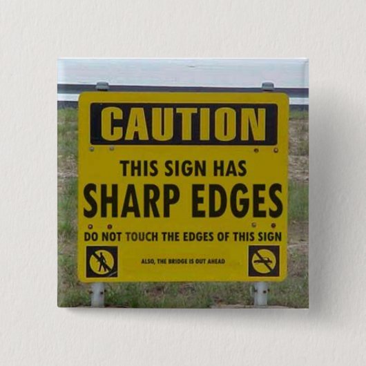 VORSICHT: dieses Zeichen hat scharfe Ränder Button (Vorderseite)