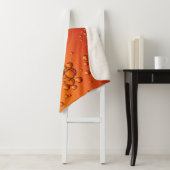 Wassertropfen auf orangefarbener Oberfläche Sherpadecke (Beispiel)
