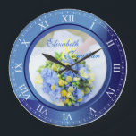 Wedding Anniversary Blue Sapphire Roman Numerals Große Wanduhr<br><div class="desc">A lovely clock in blue sapphire tones, with Roman numerals. The frame that functions as part of the clock is also a frame for your favorite wedding photograph. Keep the sample image of blue, yellow and green Spring floral bouquet, or replace it with your own image for full personalization. Add...</div>