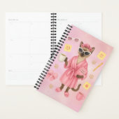 Weibliche Katze hält Terminkalender Planer (Anzeige)