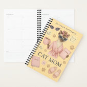 Weibliche Katze hält Terminkalender Planer (Anzeige)