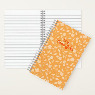 Weiche Blumenmuster auf orangefarbenem Hintergrund Notizblock