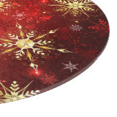 Weihnachten Goldene Schneeflocken im roten Hinterg Schneidebrett (Ecke)