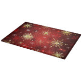 Weihnachten Goldene Schneeflocken im roten Hinterg Schneidebrett (Ecke)