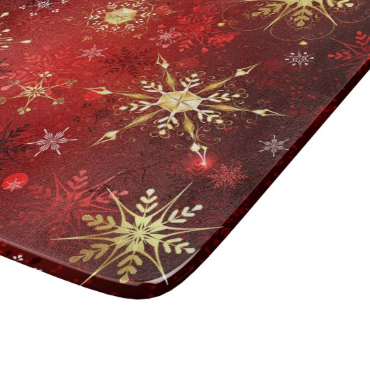 Weihnachten Goldene Schneeflocken im roten Hinterg Schneidebrett (Ecke)