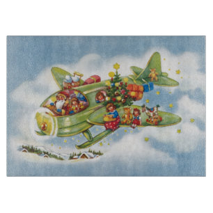 Weihnachtlicher Santa Claus, der ein Flugzeug flie Schneidebrett