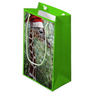 Weihnachts-Giraffe mit einem Weihnachtshut Kleine Geschenktüte