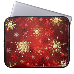 Weihnachts-Goldschneeflocken auf rotem Hintergrund Laptopschutzhülle