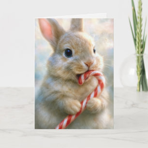 Weihnachts-Hase knabbert an einem Zuckerstangen Karte