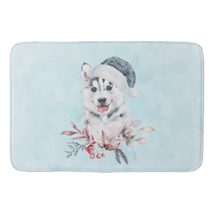 Weihnachts-Husky-Hund in einer Weihnachtsmannmütze Badematte
