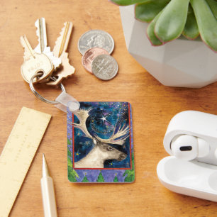 Weihnachts-Rentier am Abend mit einem Shining-Star Schlüsselanhänger