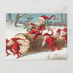 Weihnachts-Santa-Elfen rutschen auf einem Baumstam Feiertagspostkarte