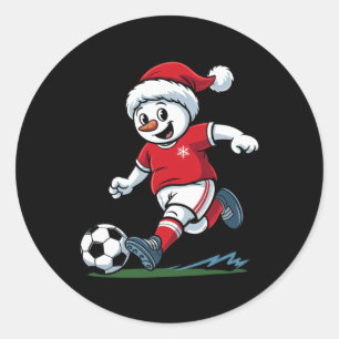 Weihnachts-Schneemann spielt Fußball lustiger Spie Runder Aufkleber