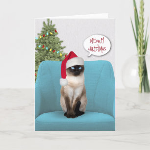 Weihnachts-Siamesenkatze auf einem Stuhl Feiertagskarte