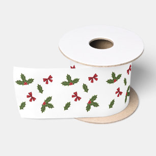 Weihnachts-Stechpalmen-Pflanze und rote Schleifen Satinband