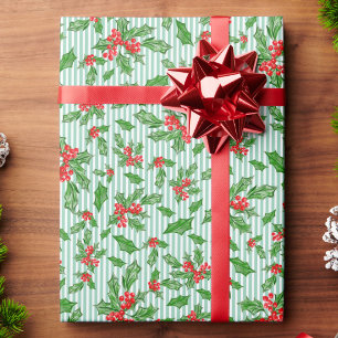 Weihnachts-Stechpalmenblätter und rote und grüne B Geschenkpapier