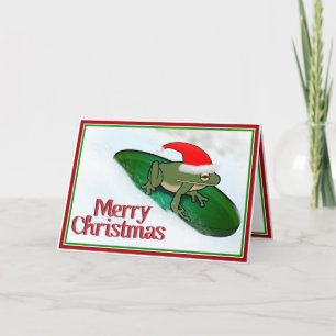 Weihnachtsfrosch rast durch den Schnee auf einem S Feiertagskarte