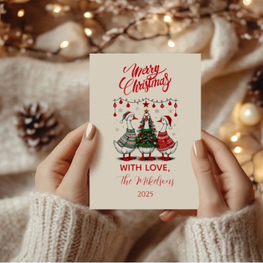 Weihnachtsgänse in gemütlichen Pullovern Feiertagskarte