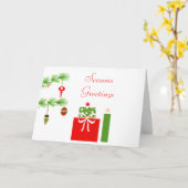 Weihnachtsgeschenke unter der Weihnachtskarte des Karte (Gelbe Blume)