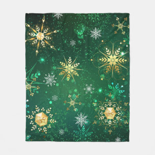 Weihnachtsgoldschneeflocken auf grünem Hintergrund Fleecedecke
