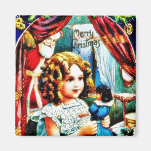 Weihnachtsgruß mit einem Mädchen, das ein Magnet