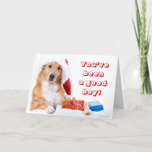 Weihnachtshund mit dem Geweih und den bunten Feiertagskarte