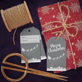 Weihnachtsmann mit Schlitten und Rentieren über de Geschenkanhänger