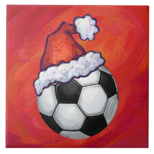 Weihnachtsmannmütze Fußball auf Rot Fliese