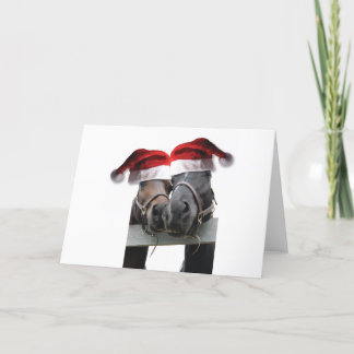 Weihnachtspferde mit Weihnachtsmannmützen Feiertagskarte