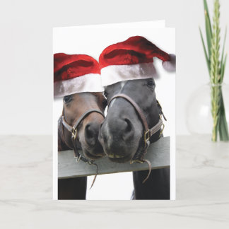 Weihnachtspferde mit Weihnachtsmannmützen Feiertagskarte