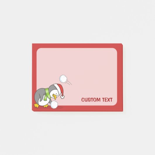 Weihnachtspinguin bekommt eine Schneeball Post-it Klebezettel (Vorderseite)