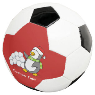 Weihnachtspinguin mit Schneebälle schwingen Fußball