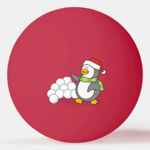 Weihnachtspinguin mit Schneebälle schwingen Tischtennisball