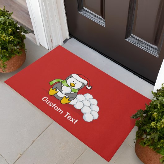 Weihnachtspinguin sitzend mit Schneebälle Fußmatte