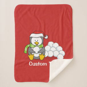 Weihnachtspinguin sitzend mit Schneebälle Sherpadecke