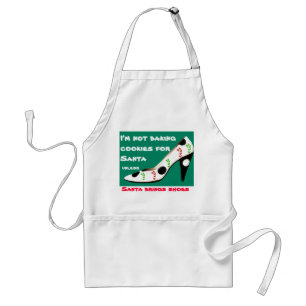 Weihnachtsplätzchen und -schuhe mit Sankt Schürze