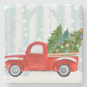 Weihnachtsroter Lieferwagen-LKW auf einer Steinuntersetzer