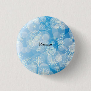 Weihnachtsschneeflocken auf blauem Hintergrund Button