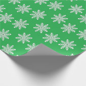 Weihnachtsschneeflocken auf Grün Geschenkpapier (Ecke)