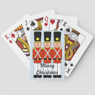 Weihnachtssoldat spielt Karten Spielkarten