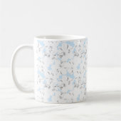 Weiße Blume auf hellblau. Kaffeetasse (Links)